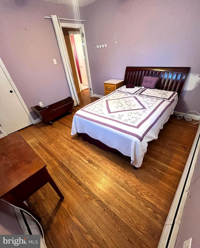 bedroom with hardwood / wood-style floors