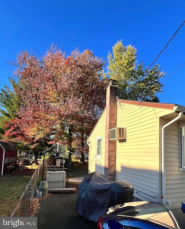 view of property exterior featuring an AC wall unit