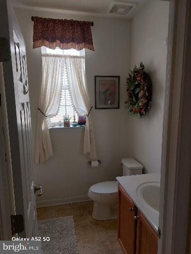 bathroom with vanity and toilet