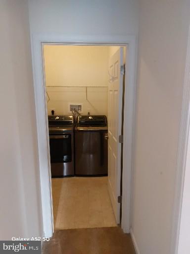 corridor featuring washer and clothes dryer