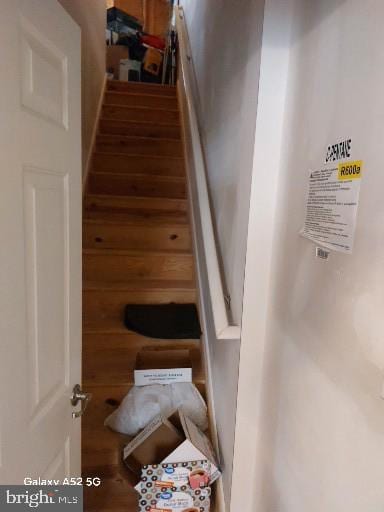 stairway featuring hardwood / wood-style flooring