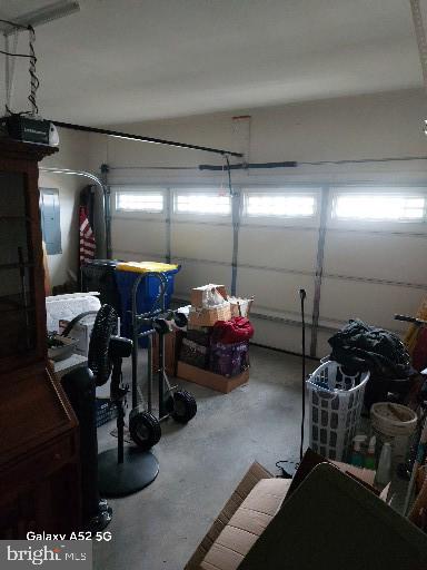 garage with electric panel and a garage door opener