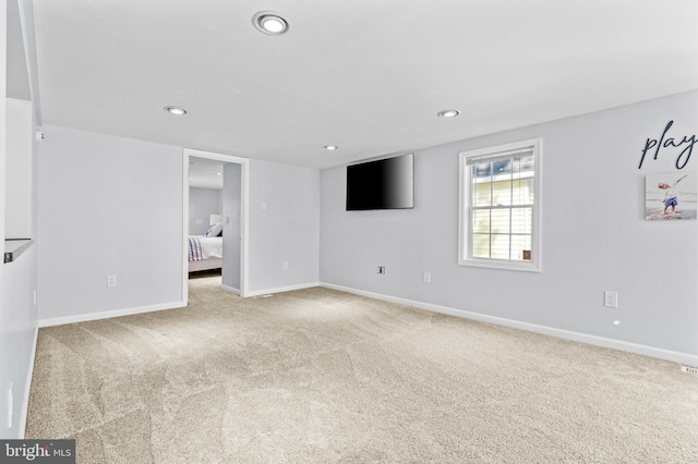 empty room featuring recessed lighting, carpet floors, and baseboards
