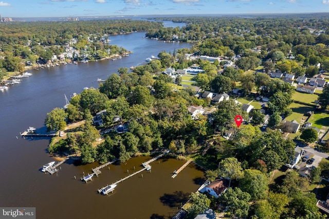 drone / aerial view featuring a water view and a forest view