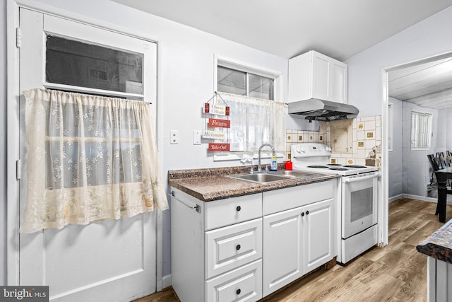 kitchen featuring sink, light wood-type flooring, electric range, white cabinets, and lofted ceiling