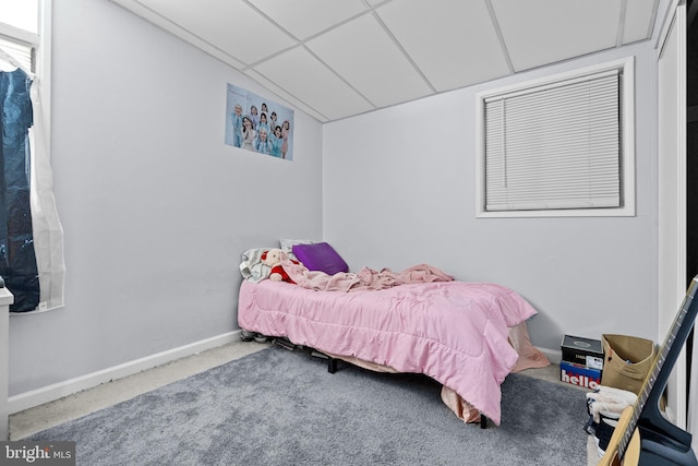 carpeted bedroom featuring a paneled ceiling