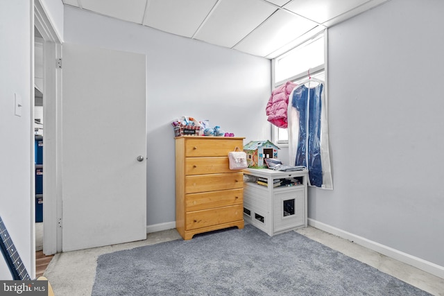 carpeted bedroom featuring a paneled ceiling