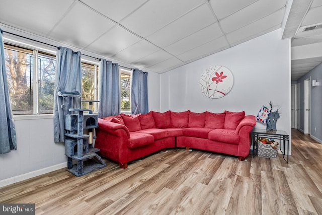 living room with a paneled ceiling and hardwood / wood-style floors