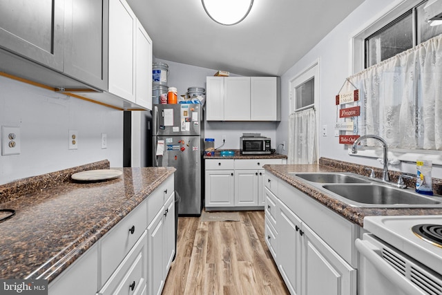 kitchen featuring sink, stainless steel appliances, white cabinets, and light wood-type flooring