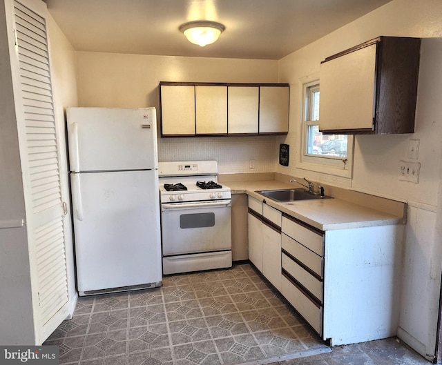 kitchen with white appliances and sink