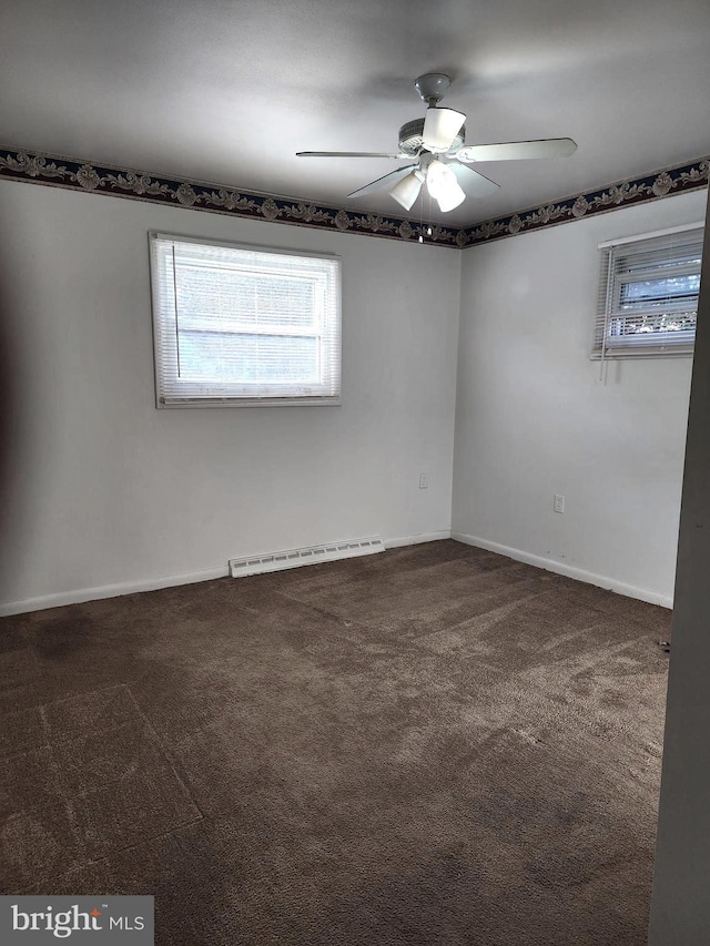 unfurnished room featuring a baseboard heating unit, dark colored carpet, and ceiling fan