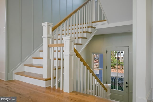 stairs featuring hardwood / wood-style floors