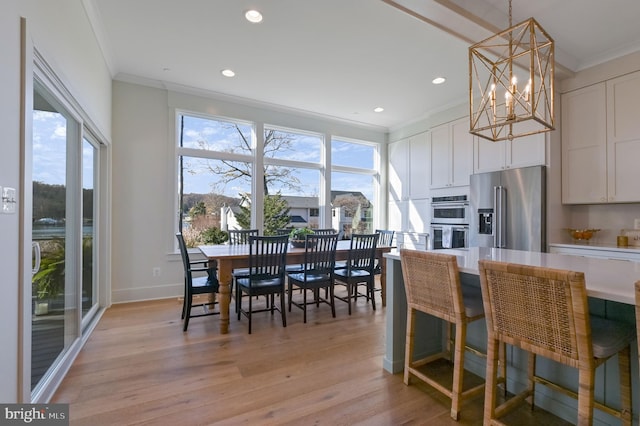 kitchen with light hardwood / wood-style floors, appliances with stainless steel finishes, a wealth of natural light, and white cabinets