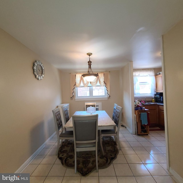 dining area with plenty of natural light and light tile patterned floors