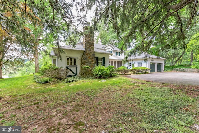 ranch-style home with a garage and a front yard