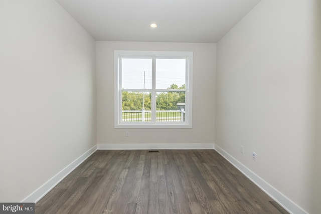 empty room featuring dark wood-type flooring