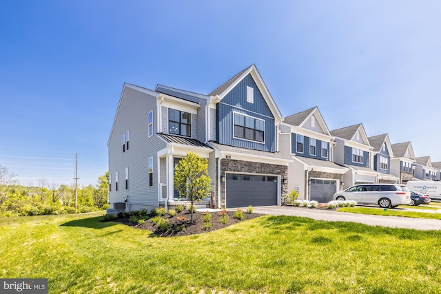 view of property featuring central air condition unit, a garage, and a front lawn