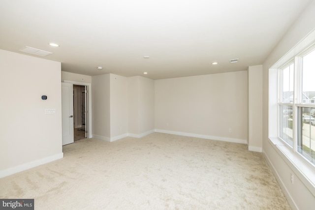 empty room with light carpet and a healthy amount of sunlight