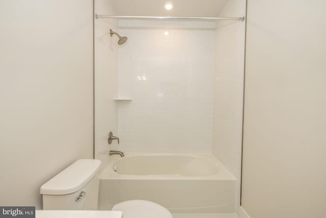 bathroom featuring tiled shower / bath and toilet