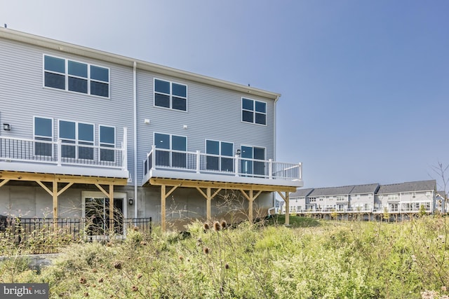 back of house featuring a deck