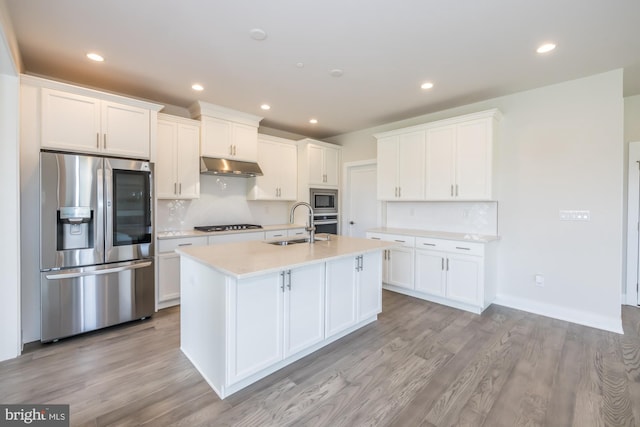 kitchen featuring white cabinets, sink, a center island with sink, light hardwood / wood-style flooring, and appliances with stainless steel finishes