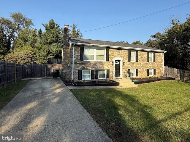 bi-level home with a front lawn