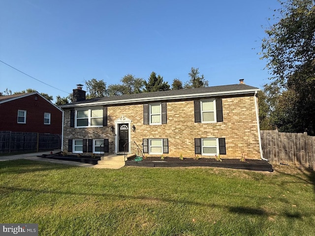 split foyer home with a front lawn