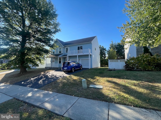 view of front facade featuring a porch, a garage, and a front lawn