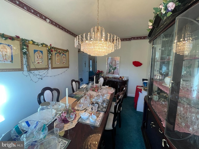 dining space featuring dark carpet and a chandelier