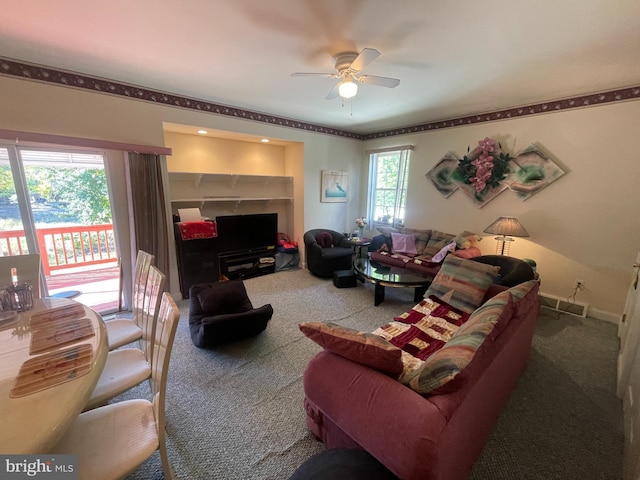 carpeted living room with ceiling fan