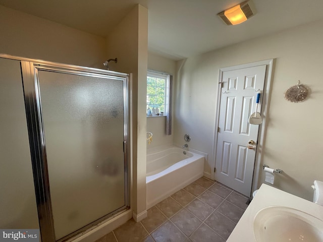 bathroom featuring tile patterned flooring, separate shower and tub, and sink