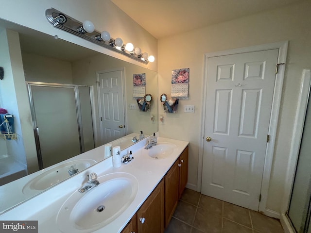 bathroom featuring vanity, tile patterned floors, and a shower with door