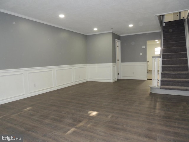 spare room with ornamental molding and dark hardwood / wood-style flooring