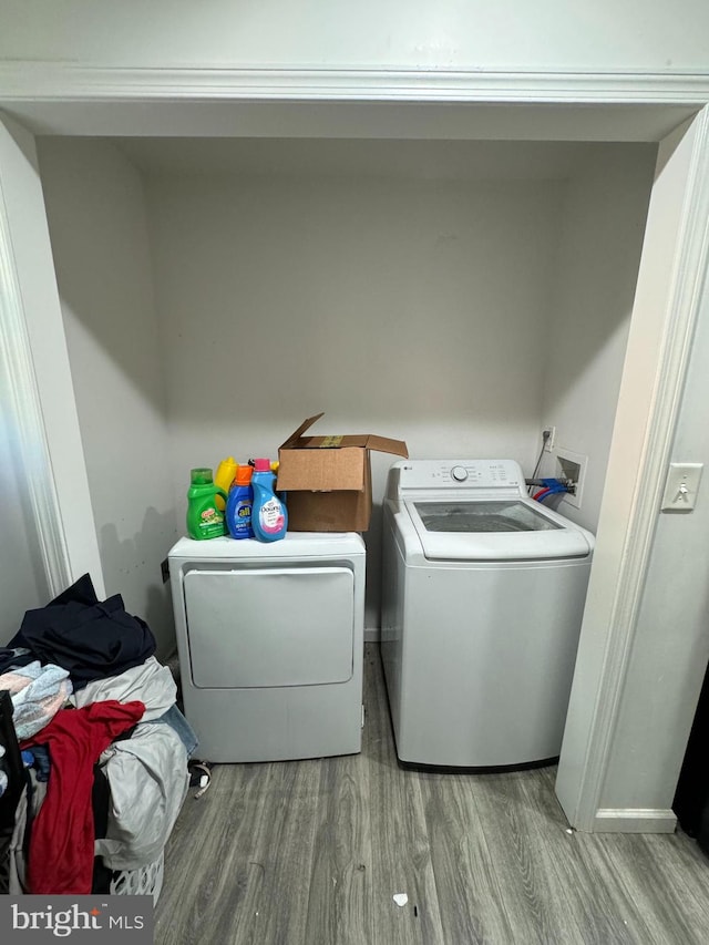 laundry room featuring washer and dryer and light wood-type flooring