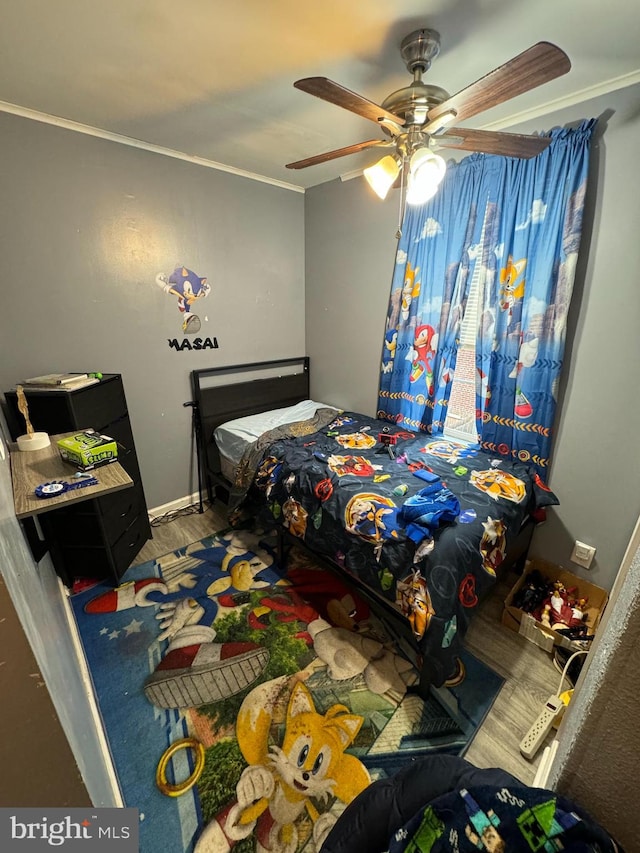 bedroom featuring ceiling fan, ornamental molding, and hardwood / wood-style floors