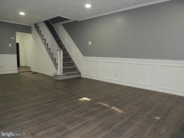 basement with dark wood-type flooring and crown molding