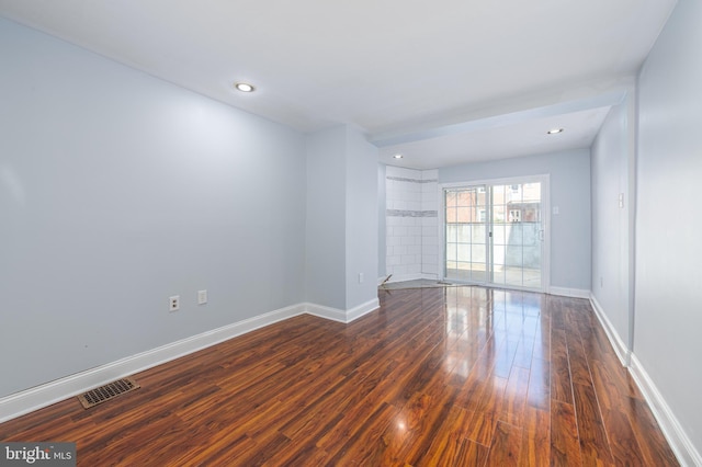 spare room with dark hardwood / wood-style flooring