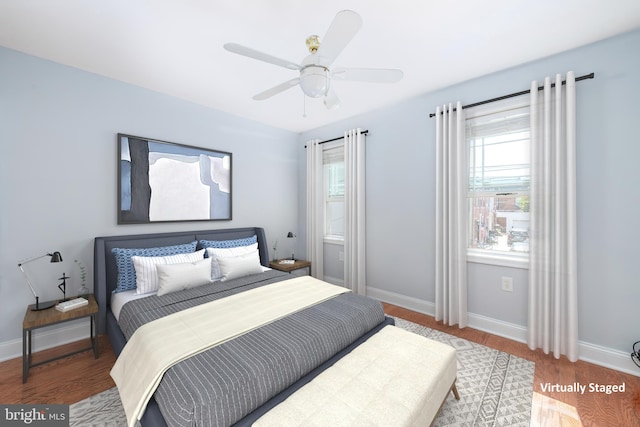 bedroom with ceiling fan and wood-type flooring