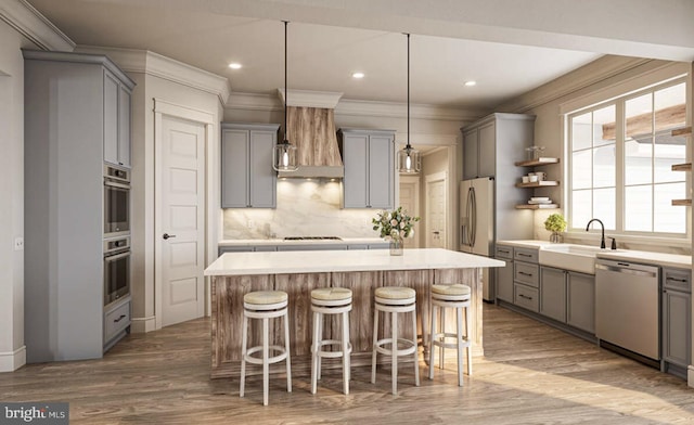 kitchen with custom range hood, wood-type flooring, appliances with stainless steel finishes, and gray cabinetry