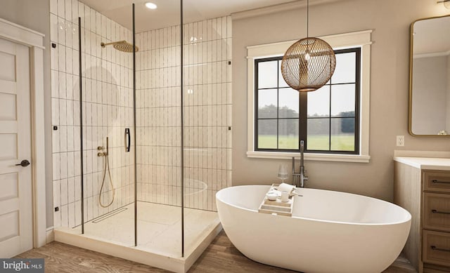 bathroom with wood-type flooring, vanity, and independent shower and bath