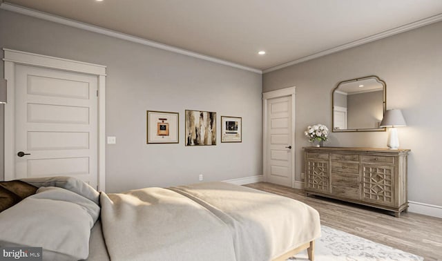 bedroom featuring ornamental molding and hardwood / wood-style flooring