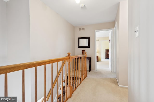 hall featuring light colored carpet