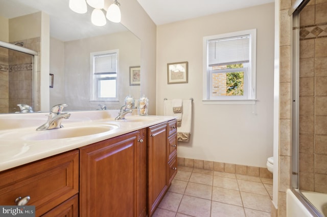 full bathroom with toilet, vanity, tile patterned floors, and combined bath / shower with glass door