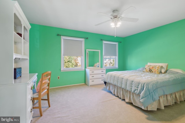 bedroom featuring ceiling fan and light carpet