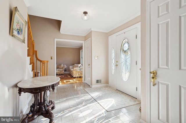 foyer featuring crown molding