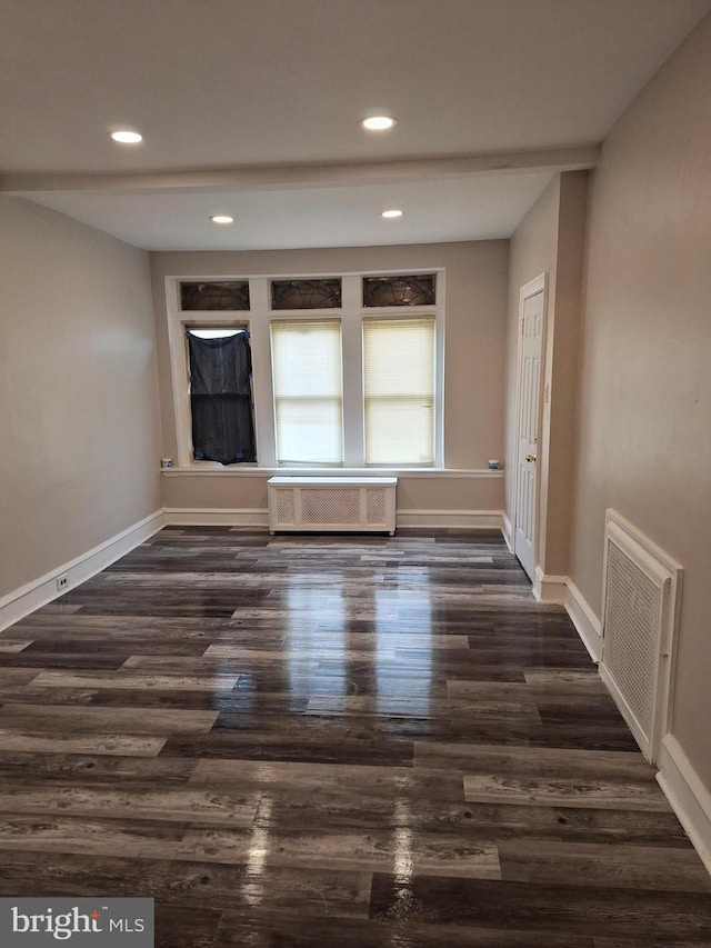 unfurnished room with dark wood-type flooring