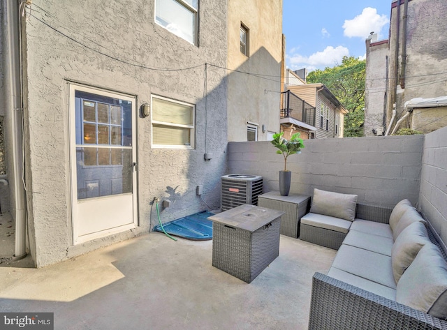 view of patio featuring an outdoor living space and central AC