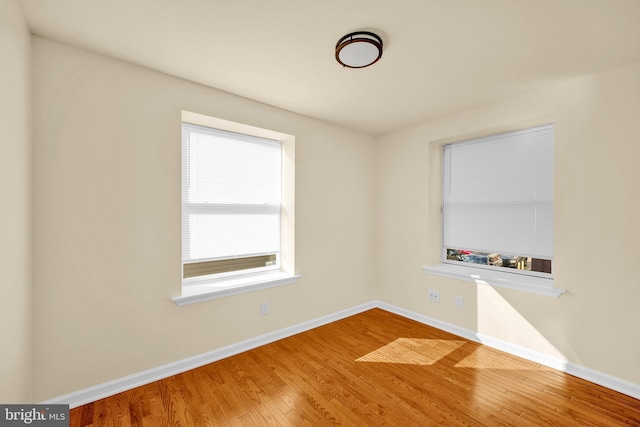 unfurnished room with wood-type flooring