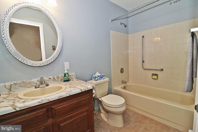 full bathroom with tile patterned floors, vanity, toilet, and tiled shower / bath