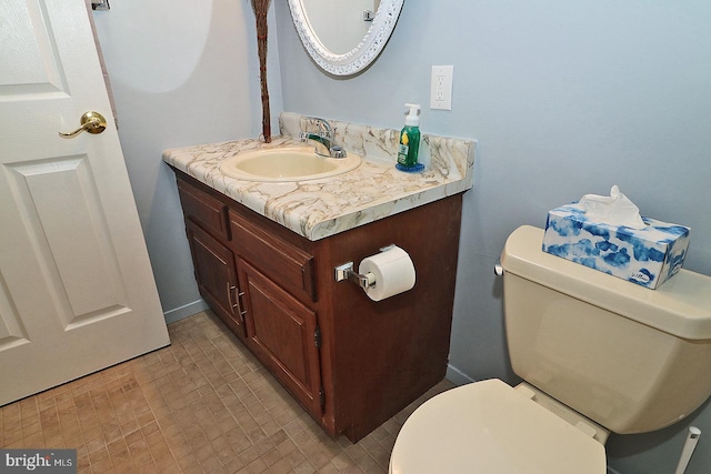 bathroom with toilet, tile patterned flooring, and vanity